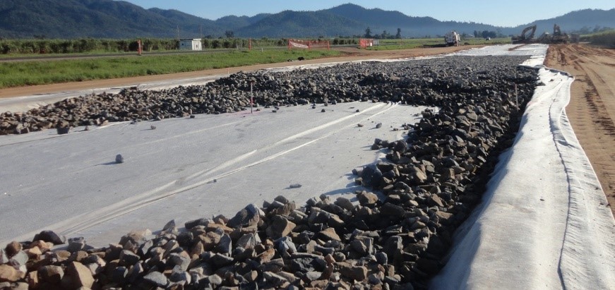 Fabric-wrapped drainage rock blanket on the Feluga Road overtaking lanes project